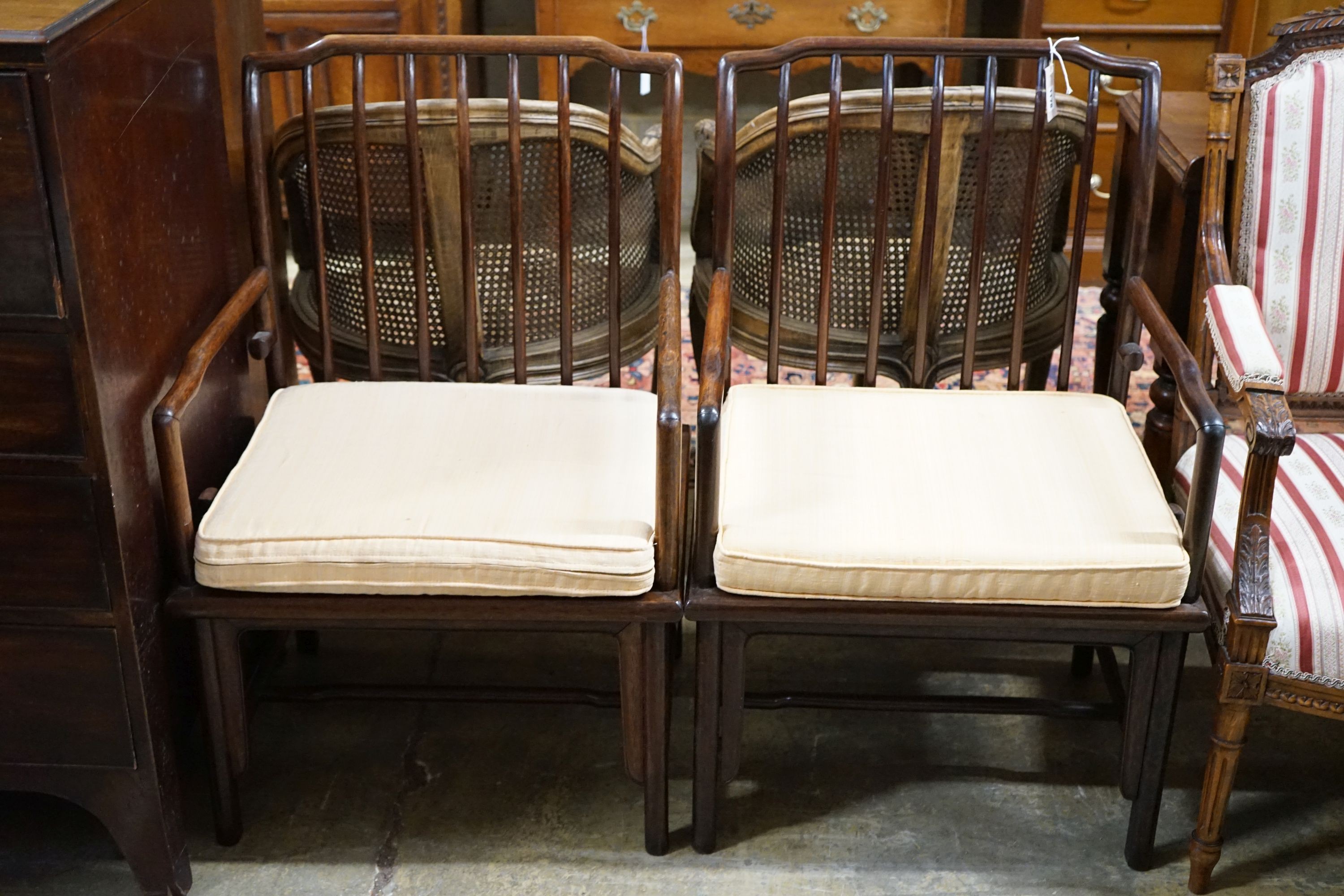 A pair of mid 20th century Chinese Hongmu elbow chairs with cushion seats, width 58cm, depth 49cm, height 92cm